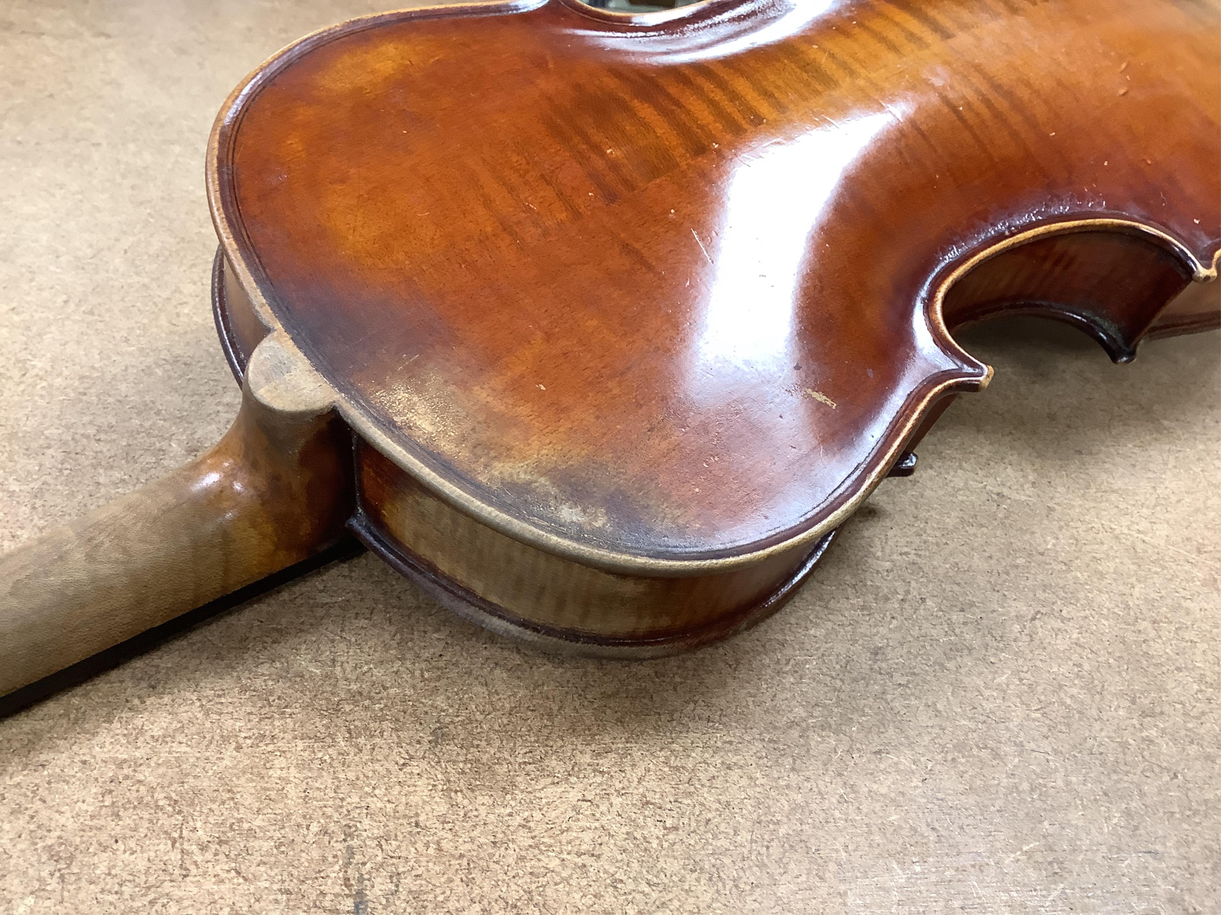 An early 20th century cased violin and cover, 60cm long